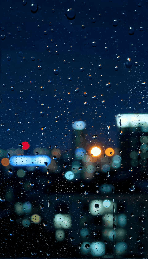 Raindrops on a night window with city bokeh — vertical GIF